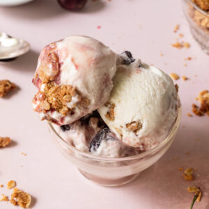 Three scoops of cherry crisp ice cream in a dish.