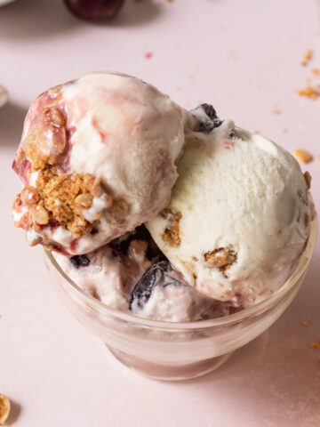Three scoops of cherry crisp ice cream in a dish.