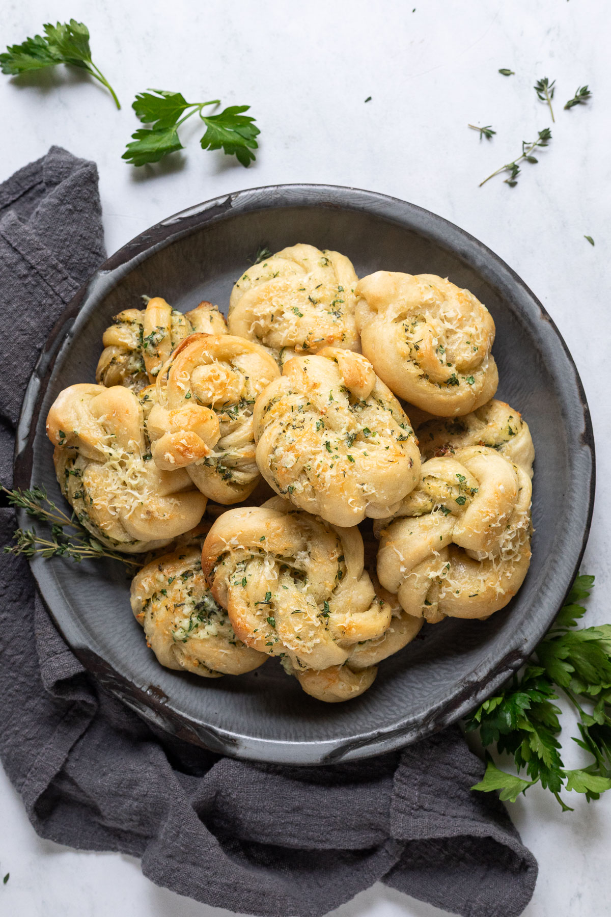 A serving platter piled high with garlic parmesan knots. 