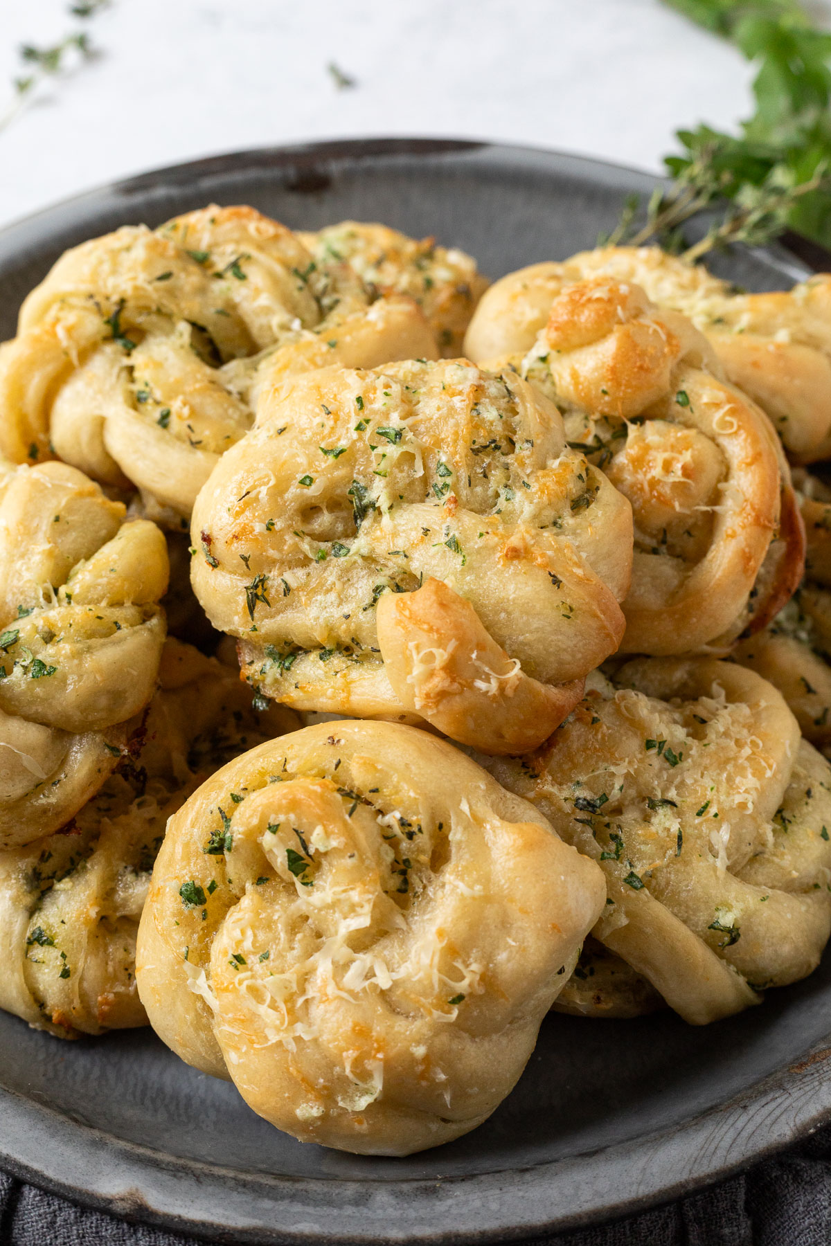 A serving platter piled high with garlic parmesan knots.