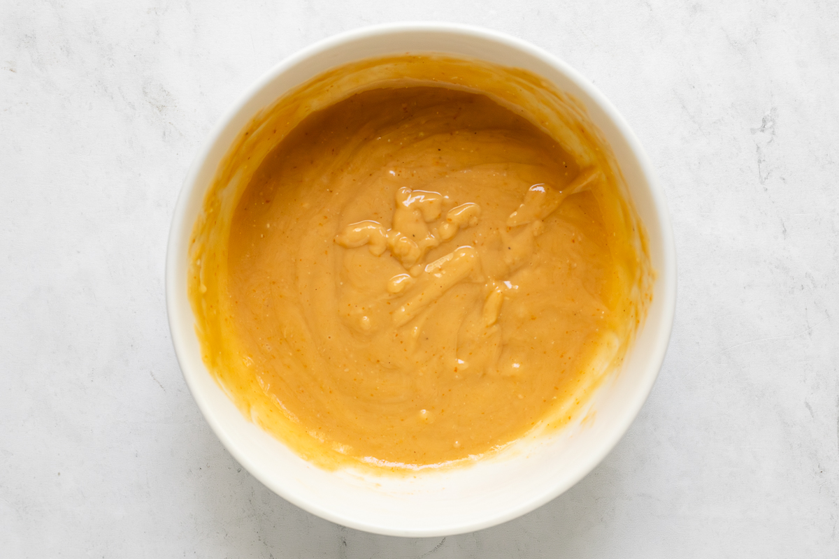 Creamy cashew dressing in a mixing bow.