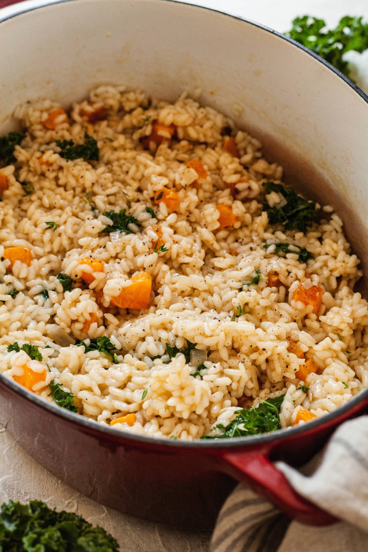Butternut squash and kale risotto in a dutch oven.