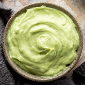 Close up of avocado crema in a bowl.