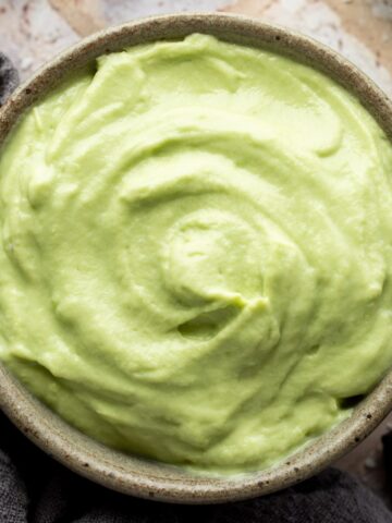 Close up of avocado crema in a bowl.
