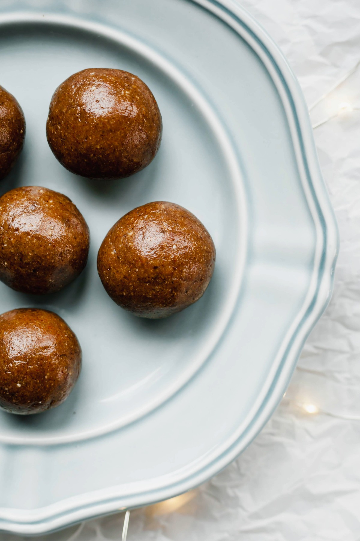 Gingerbread energy balls on a blue plate.