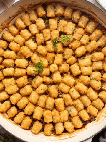 Tater tot casserole in a braiser.