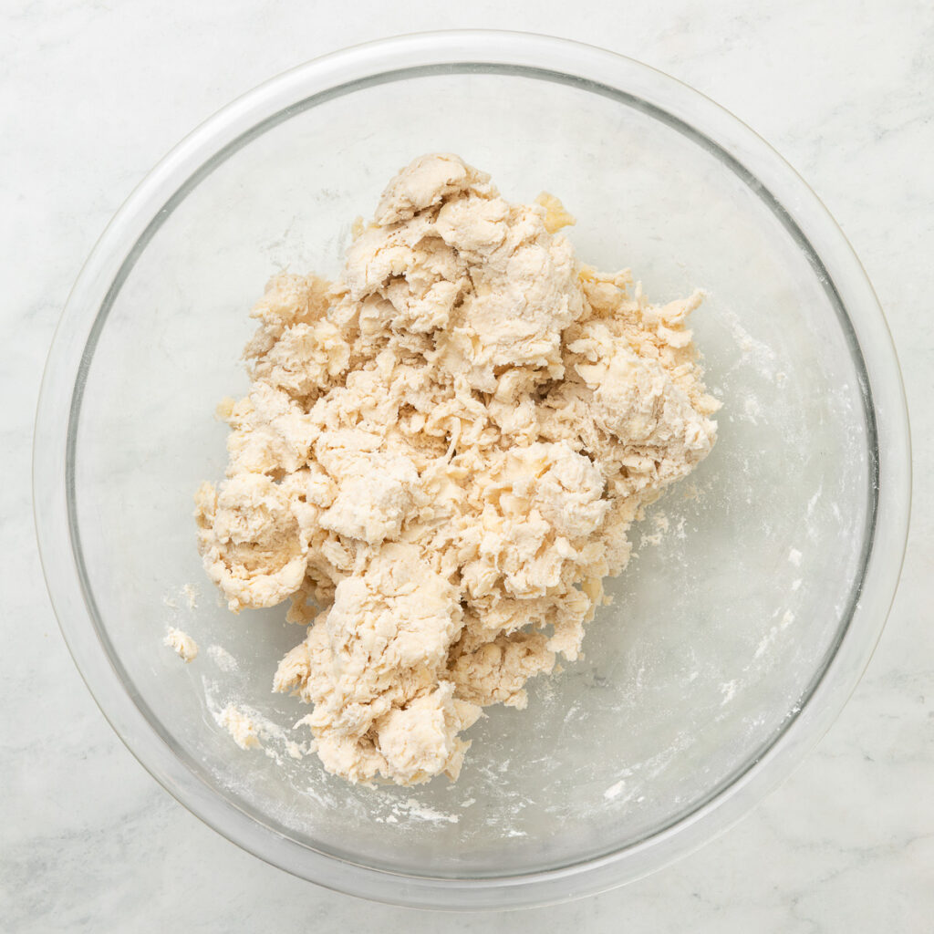 Pie dough in a bowl before being formed into discs.