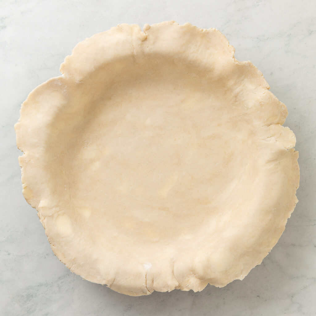 homemade all butter pie crust laid in the baking dish.
