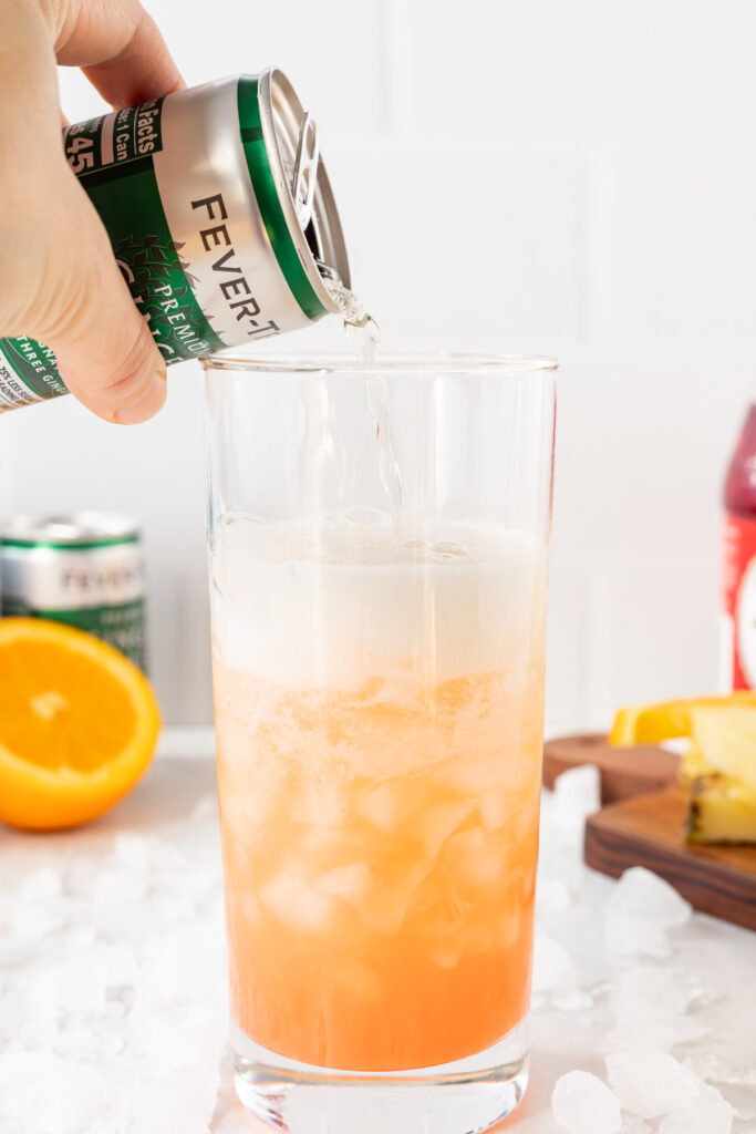 Ginger ale being poured into a cinderella mocktail.