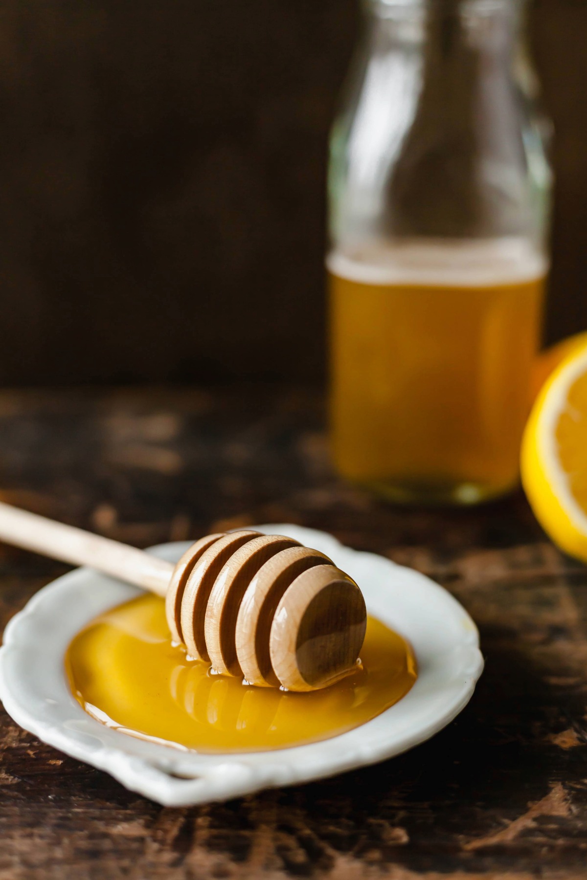 Honey on a plate with a honey stirrer.