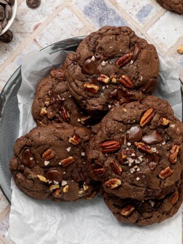 A platter full of double chocolate chip cookies.