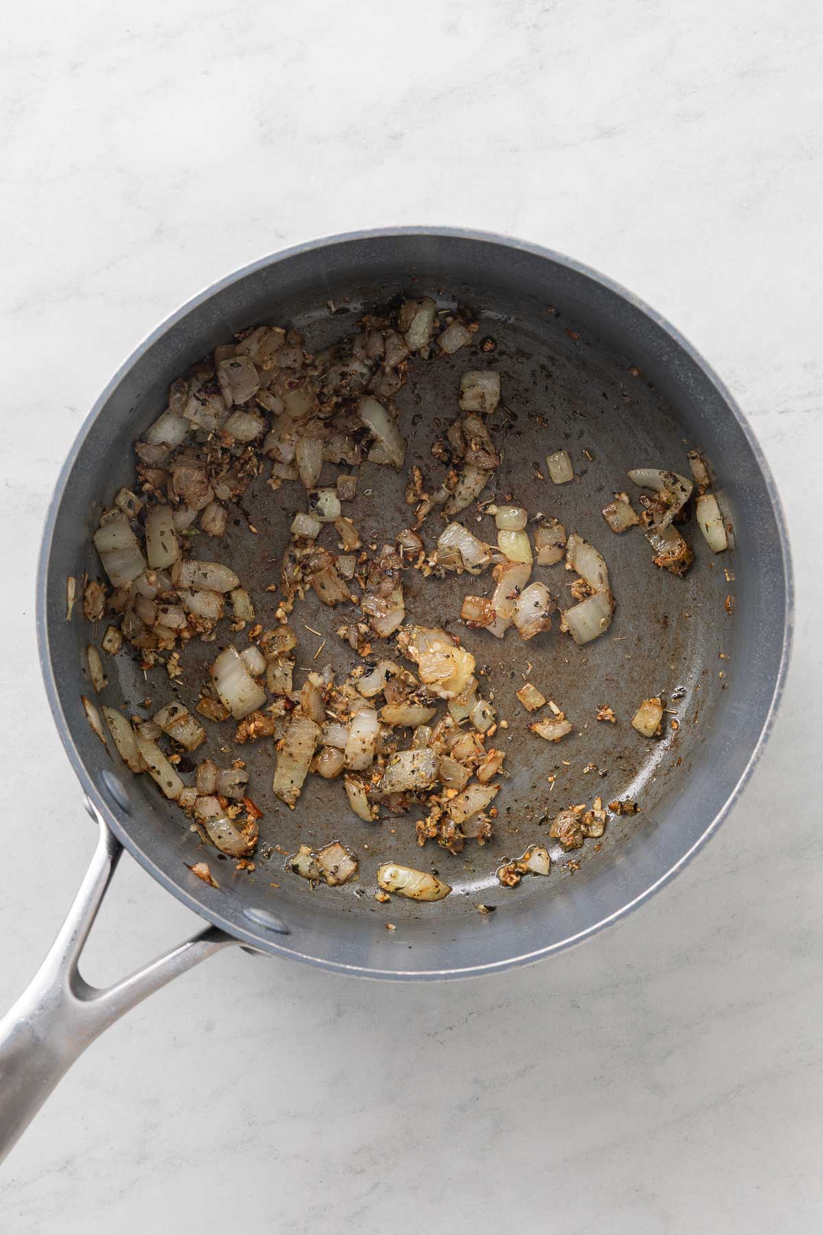Onions and garlic cooked in a pot.