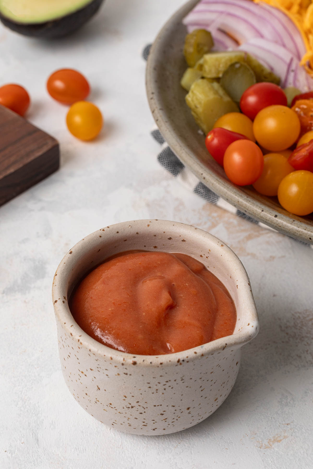 A small cup filled with dressing.
