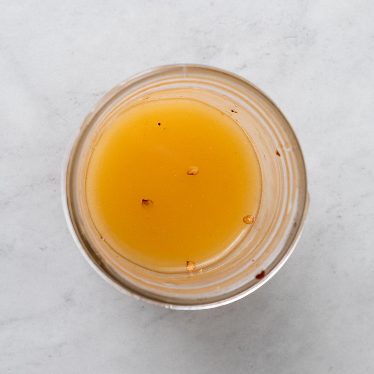 A small jar of sun dried tomato dressing.