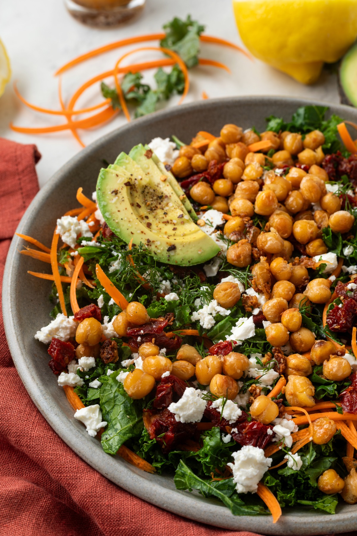 A bowl of chickpea and kale salad ¾ in the frame.