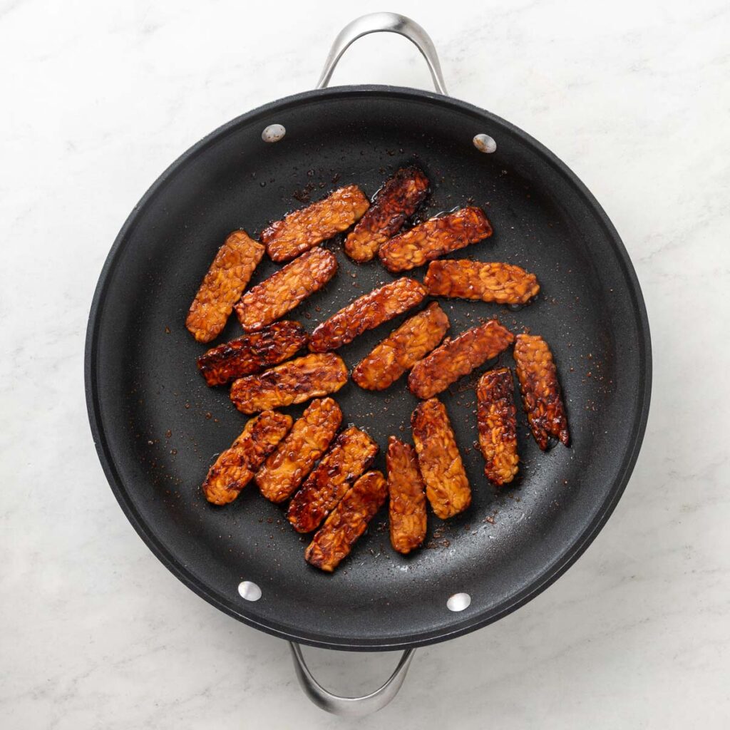 Cooked tempeh in a pan.